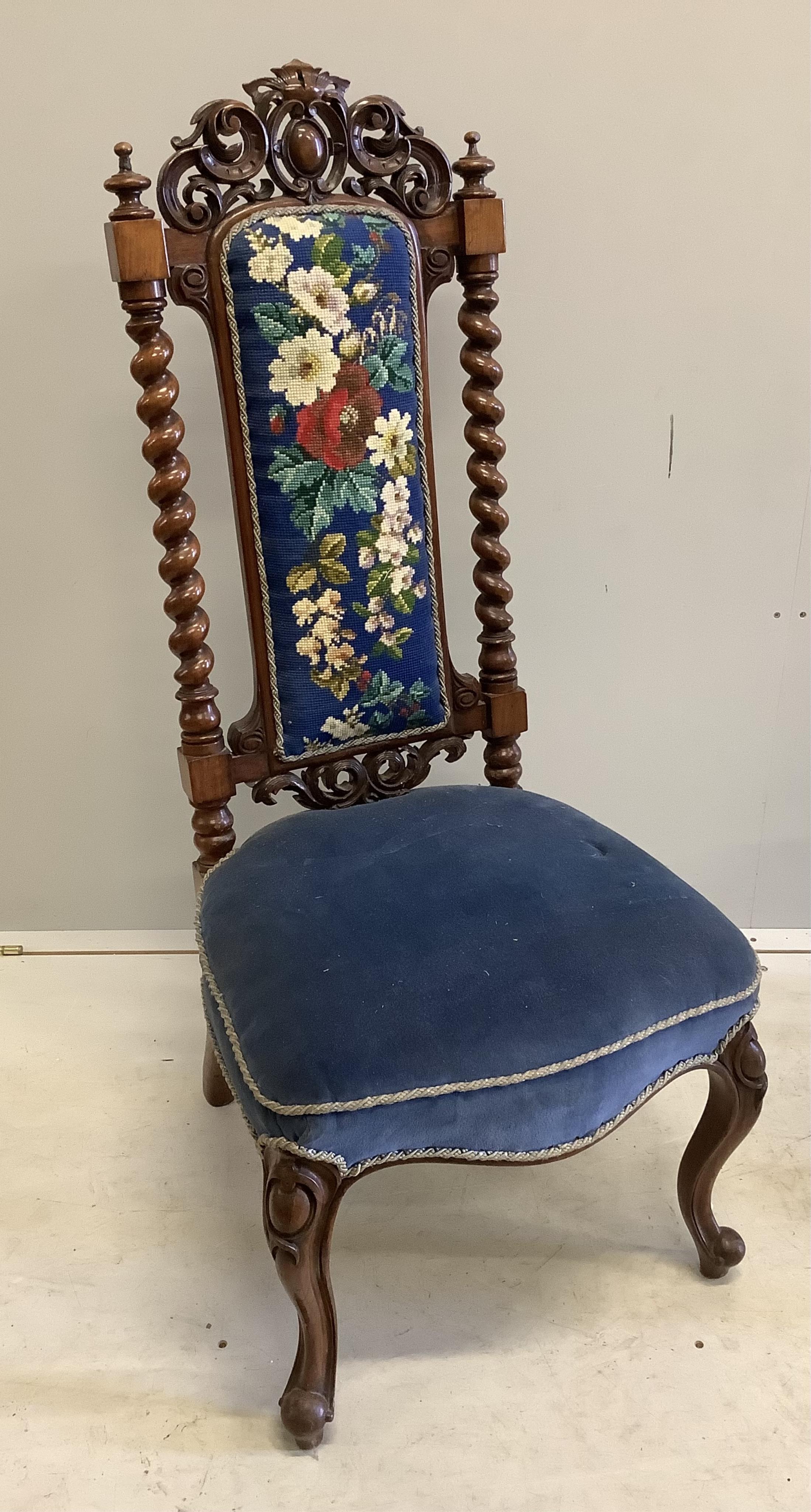 A pair of Victorian carved walnut side chairs with polychrome floral upholstered backs, width 46cm, depth 40cm, height 104cm. Condition - fair to good